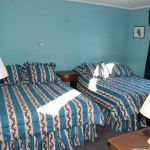 Blue motel room with two beds